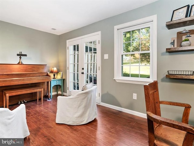 sitting room featuring wood finished floors, french doors, and baseboards