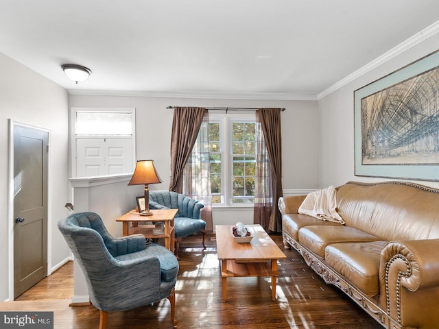 living room with baseboards, wood finished floors, and crown molding