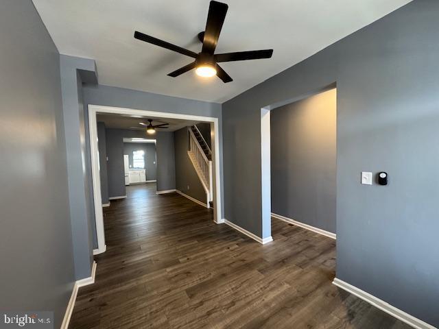 interior space featuring ceiling fan and dark wood-type flooring