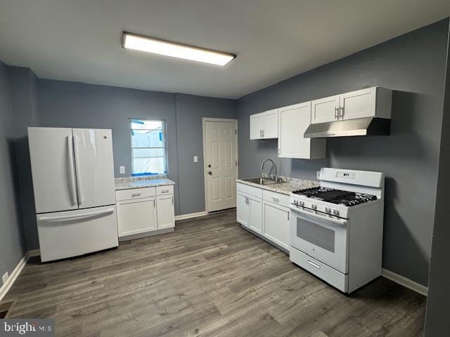 kitchen with white appliances, white cabinetry, sink, and dark wood-type flooring