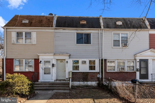 view of property with entry steps and brick siding