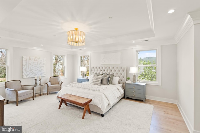 bedroom featuring light wood-style flooring, recessed lighting, baseboards, ornamental molding, and a raised ceiling