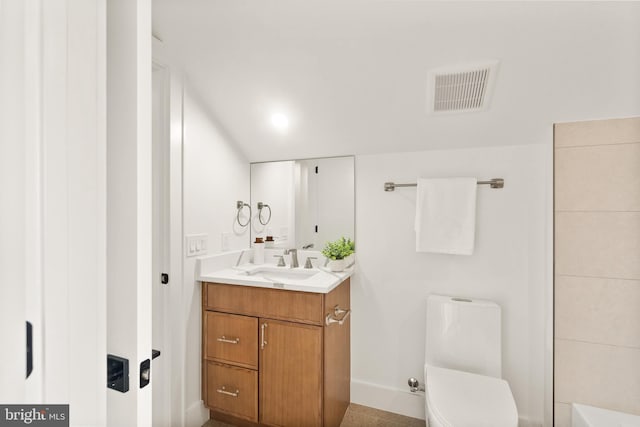 bathroom with visible vents, vanity, and toilet