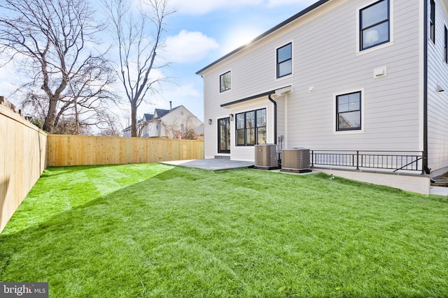 back of house featuring a fenced backyard, a patio, a lawn, and central air condition unit