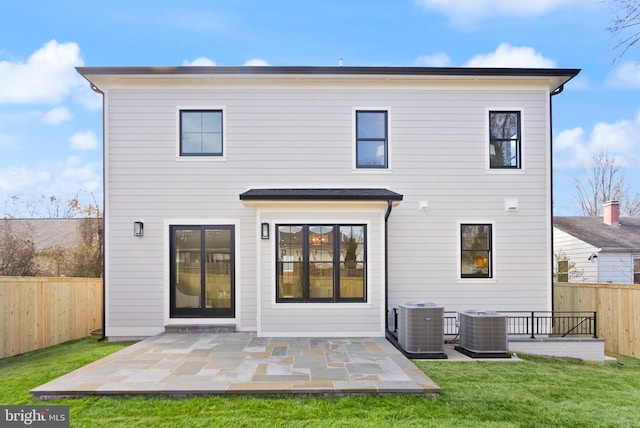 back of house featuring a patio area, a lawn, a fenced backyard, and central air condition unit