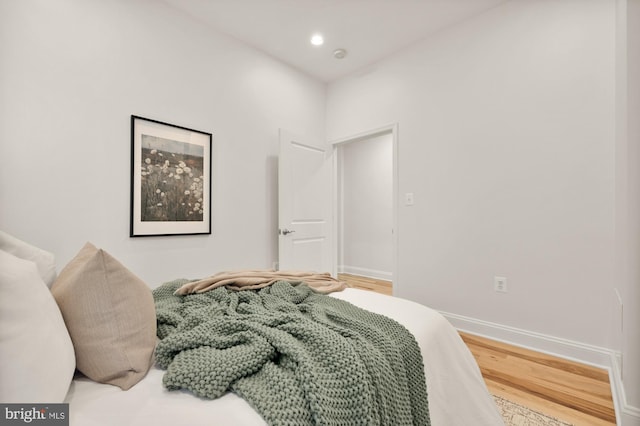 bedroom featuring recessed lighting, wood finished floors, and baseboards