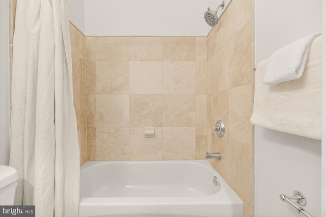 bathroom with shower / bath combination with curtain and toilet