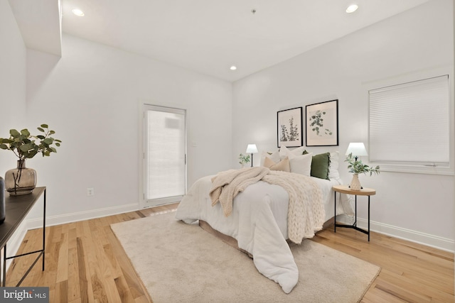 bedroom featuring recessed lighting, wood finished floors, and baseboards