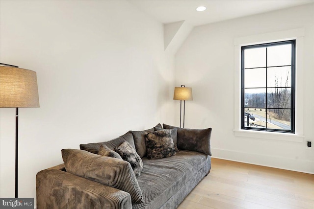 living room with baseboards, light wood-style flooring, and recessed lighting