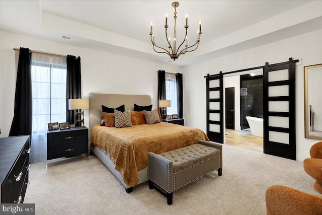 bedroom with a barn door, a notable chandelier, light carpet, visible vents, and a raised ceiling