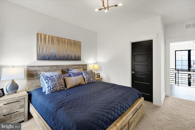 bedroom featuring visible vents, a chandelier, and light colored carpet