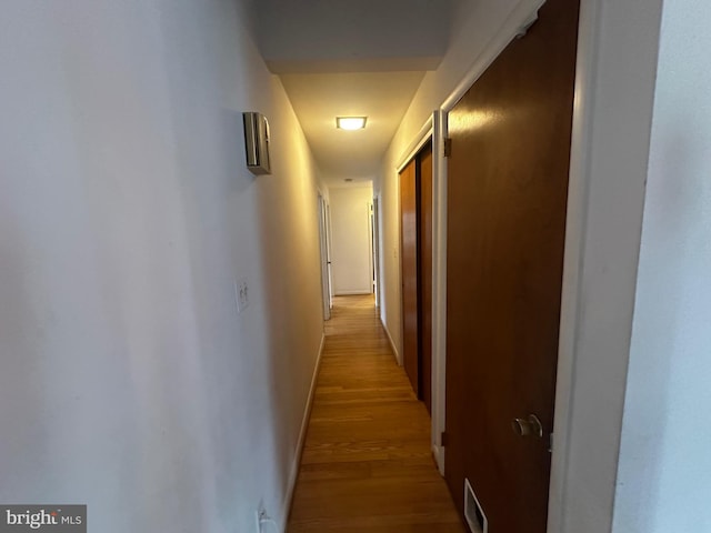 hallway with visible vents and light wood-style floors