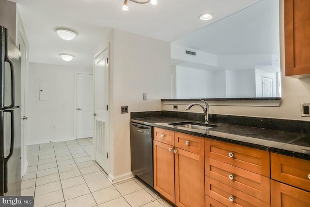 kitchen featuring black appliances, visible vents, a sink, and light tile patterned flooring