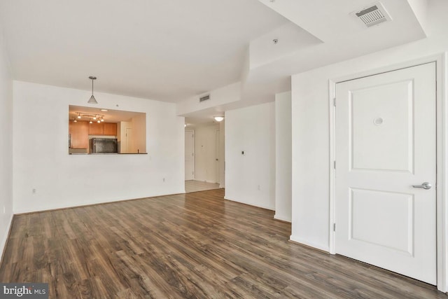 unfurnished living room with dark wood finished floors and visible vents