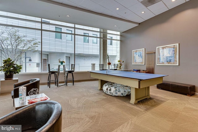 game room featuring baseboards, recessed lighting, a drop ceiling, and light colored carpet