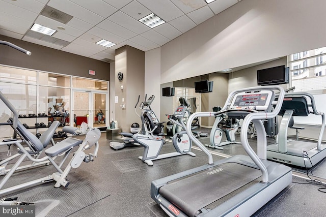 exercise room with visible vents and a paneled ceiling