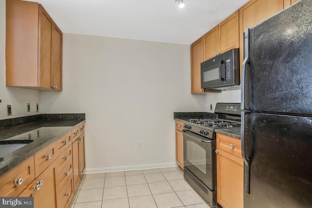 kitchen with light tile patterned floors, black appliances, brown cabinetry, and dark stone countertops