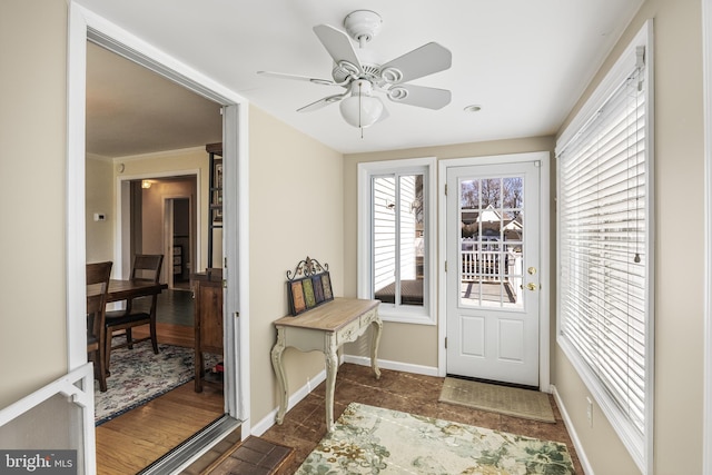 entryway featuring a ceiling fan and baseboards