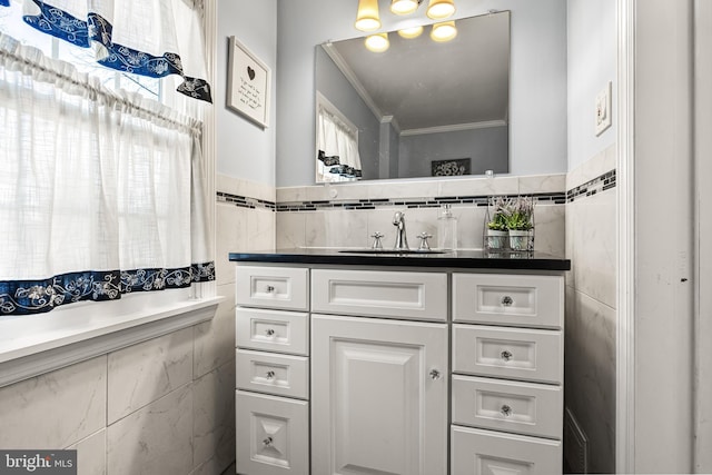 bathroom with ornamental molding, tile walls, and vanity