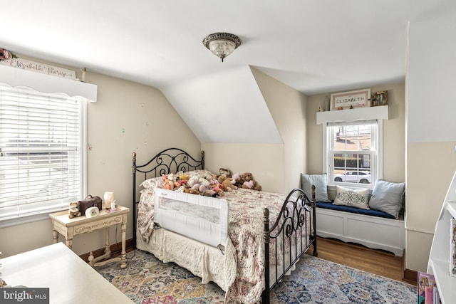 bedroom featuring vaulted ceiling and wood finished floors