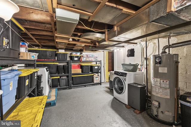 unfinished below grade area with gas water heater and washer and clothes dryer