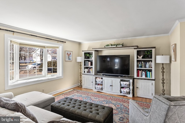 living area with crown molding, baseboards, and wood finished floors