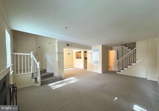 interior space featuring stairway, carpet flooring, visible vents, and baseboards