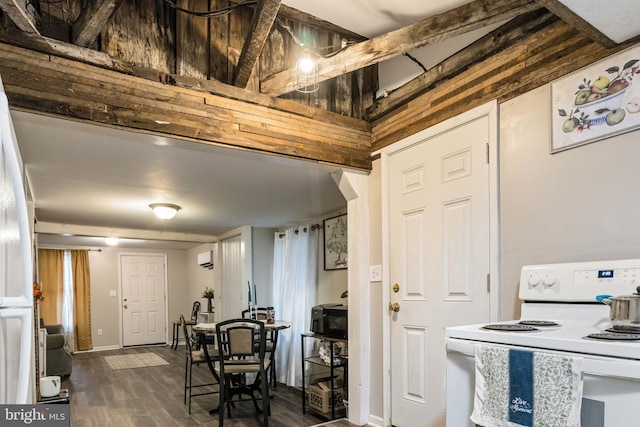 kitchen featuring baseboards, white range with electric stovetop, black microwave, and dark wood-style flooring