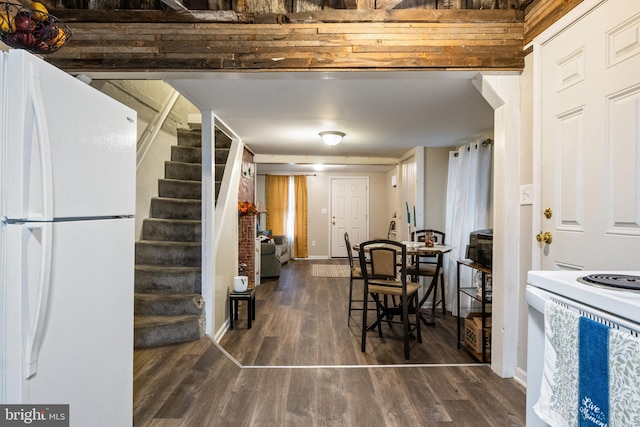 dining room featuring baseboards, stairway, and dark wood-style flooring