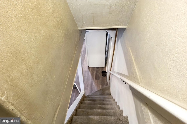 staircase with a textured wall