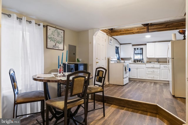 dining space with beam ceiling and dark wood-style flooring