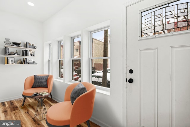 living area with recessed lighting, wood finished floors, and baseboards