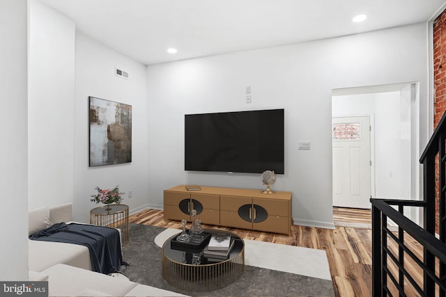 living room featuring recessed lighting, visible vents, and wood finished floors