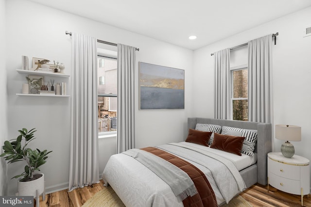 bedroom with recessed lighting, multiple windows, visible vents, and wood finished floors