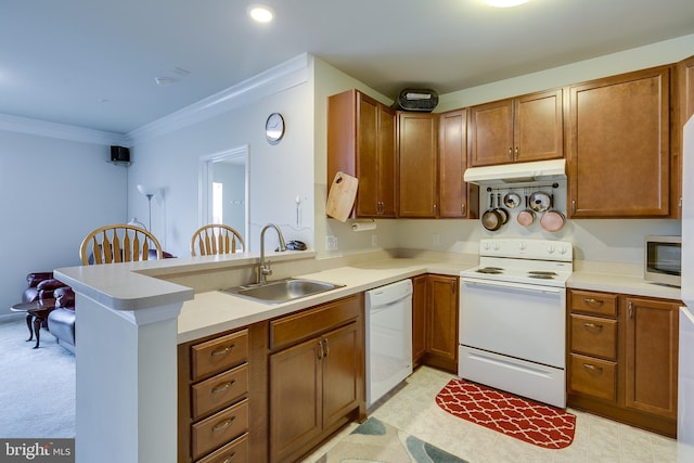 kitchen with crown molding, a sink, a peninsula, white appliances, and under cabinet range hood