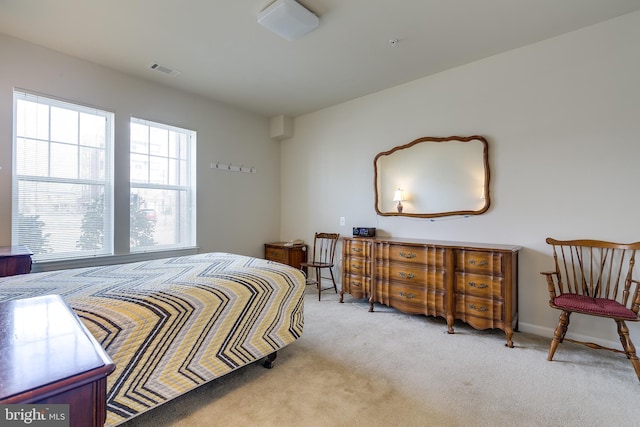 carpeted bedroom with visible vents and baseboards