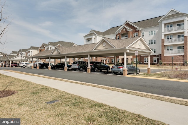 view of road featuring curbs, sidewalks, and a residential view