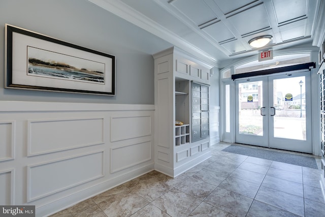 doorway with a wainscoted wall, french doors, light tile patterned floors, and a decorative wall