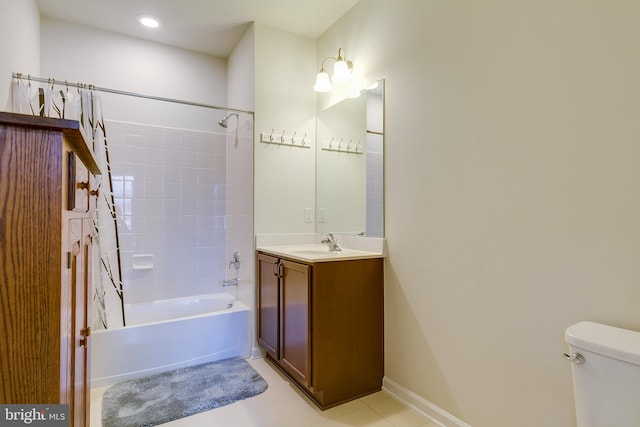 bathroom with baseboards, toilet, tile patterned floors,  shower combination, and vanity