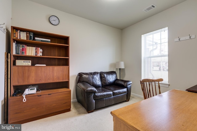 living room with light carpet, baseboards, and visible vents