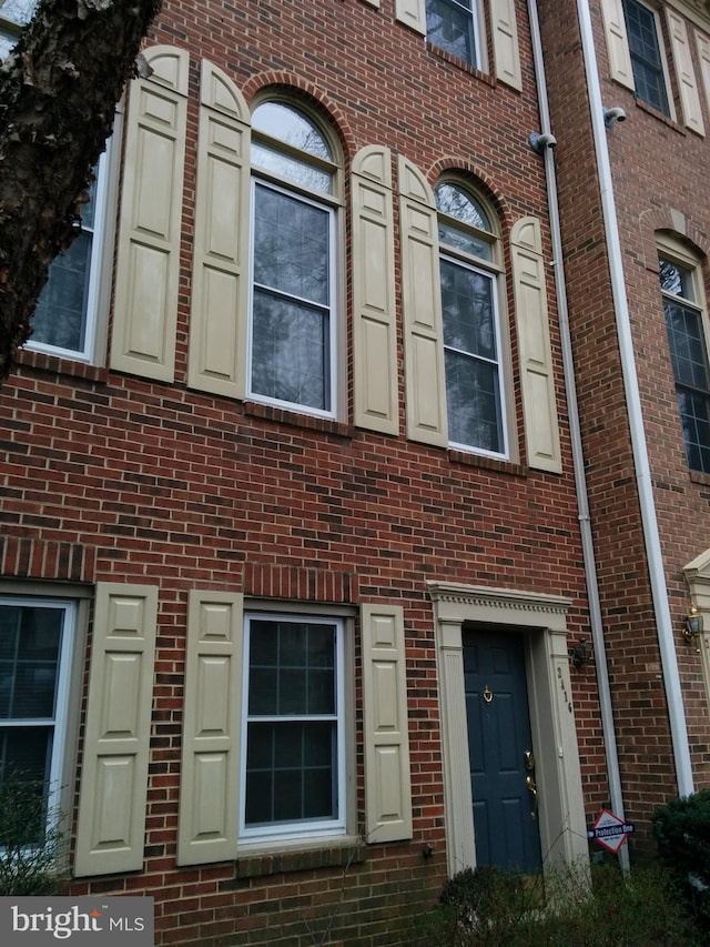 exterior space with brick siding