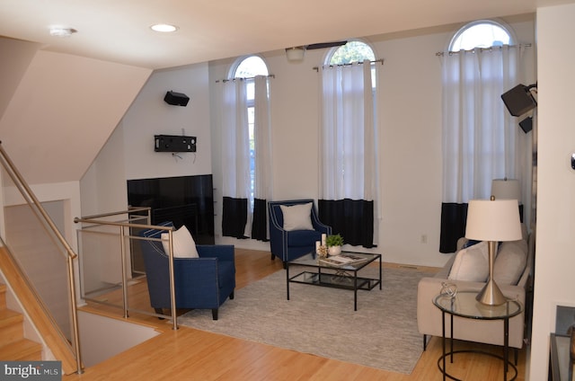 living room featuring a fireplace, wood finished floors, and recessed lighting