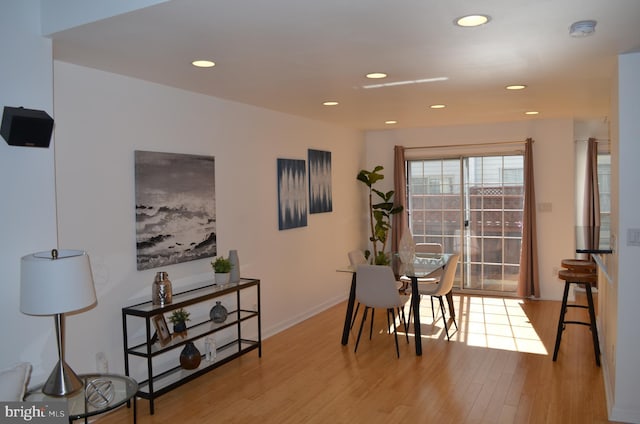 dining space with light wood finished floors, baseboards, and recessed lighting