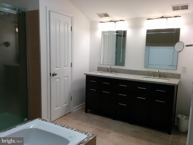 bathroom featuring double vanity, visible vents, and a sink