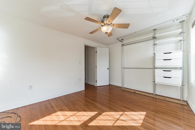 unfurnished bedroom with ceiling fan and hardwood / wood-style floors