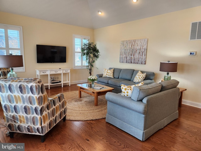 living area with lofted ceiling, recessed lighting, wood finished floors, visible vents, and baseboards