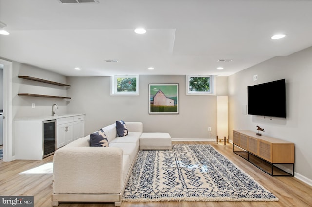 living area with wine cooler, recessed lighting, indoor wet bar, and a wealth of natural light