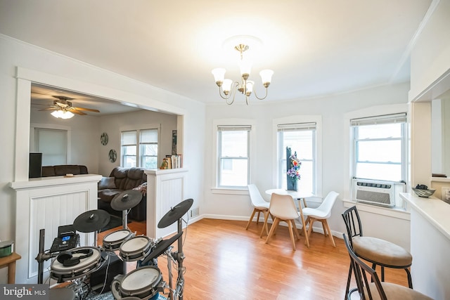 dining area with visible vents, an inviting chandelier, ornamental molding, light wood-type flooring, and baseboards