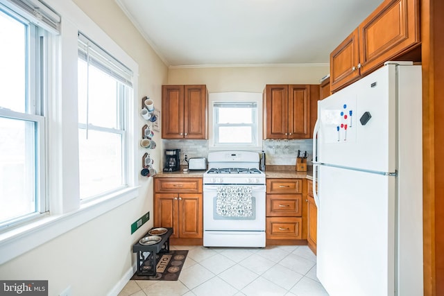 kitchen featuring white appliances, backsplash, and brown cabinets