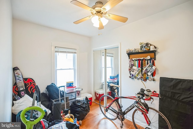 playroom with a ceiling fan and wood finished floors